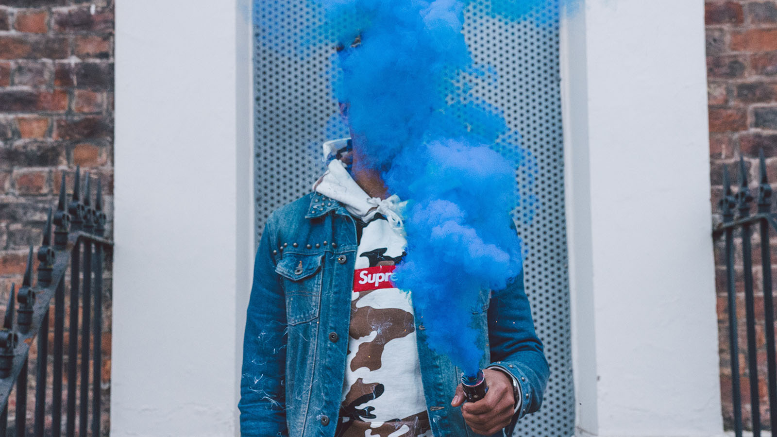 Person holding blue smoke