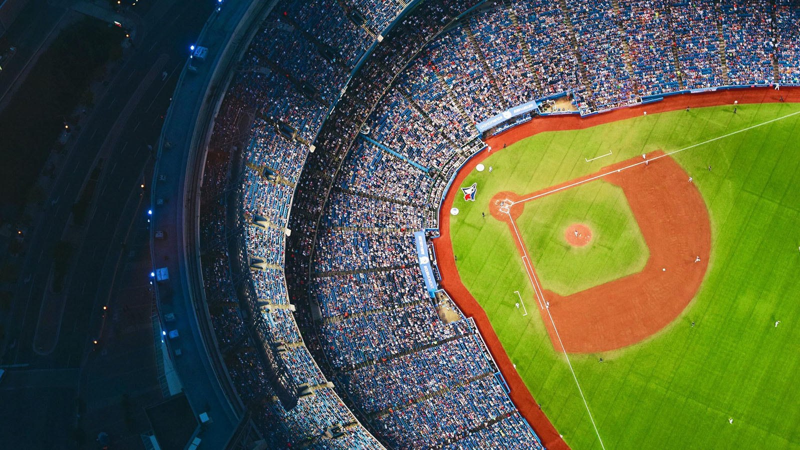 Baseball stadium with many people in the stands