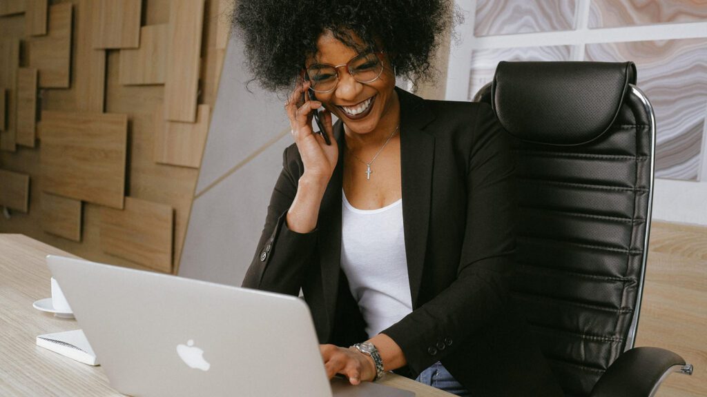 Woman on phone looking at computer