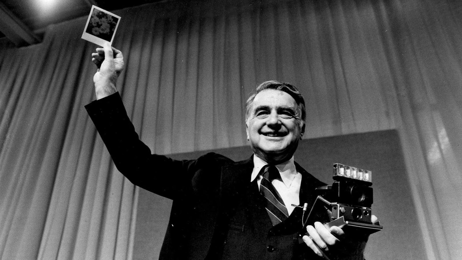 Edwin Land holding polaroid photo