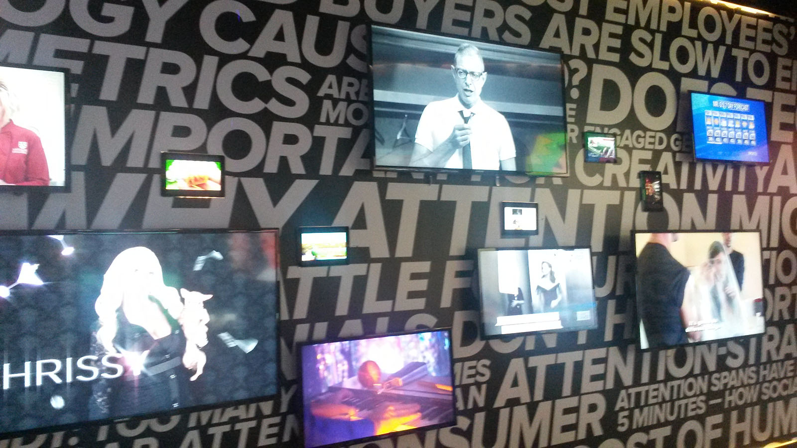 Many TVs showing different shows and movies