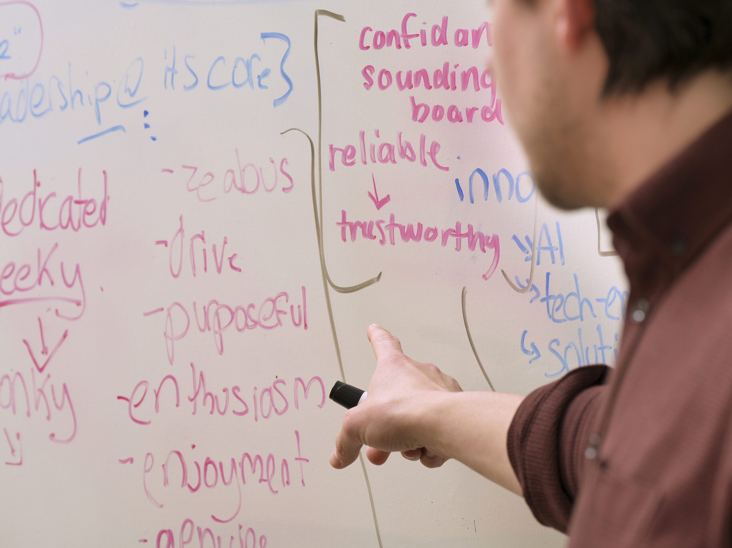 GP pointing at a whiteboard