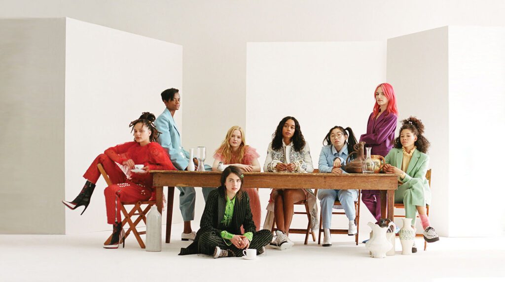 Group of people dressed in bright colors sitting around a table
