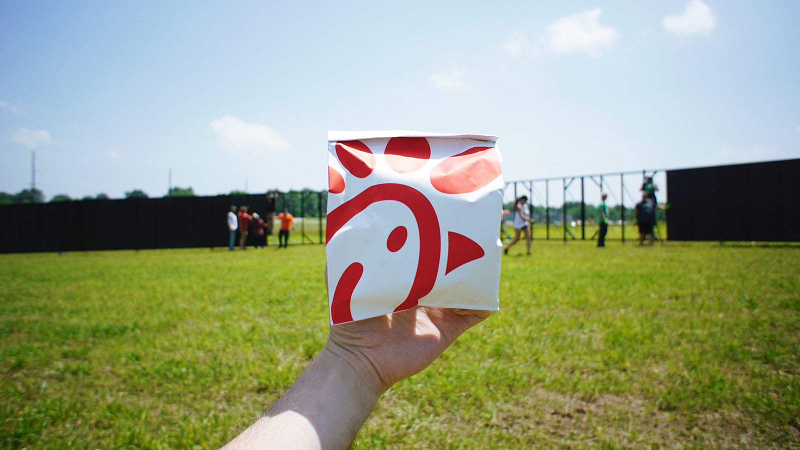 Holding a Chick-fil-A bag at the park