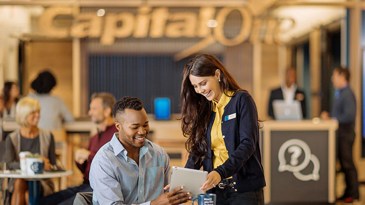CapitalOne employee and customer holding an iPad