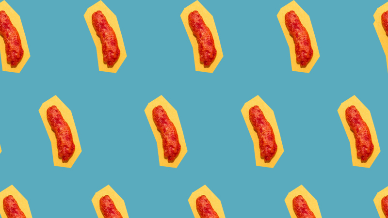 A pattern of Flamin' Hot Cheetos on yellow cut outs with a blue background