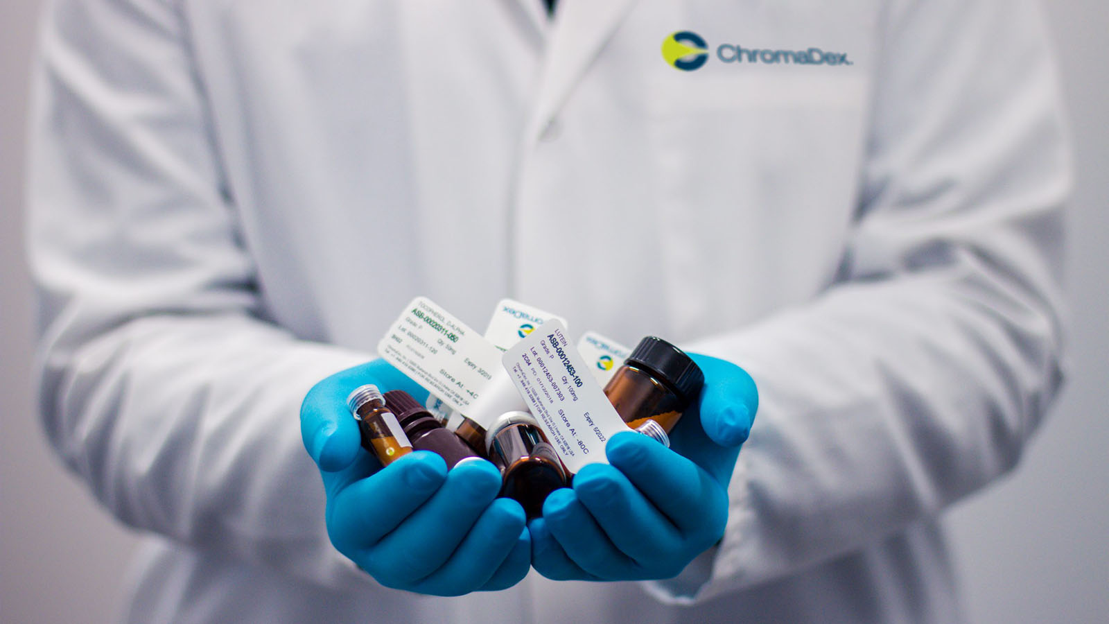 ChromaDex pharmacist holding bottles of pills