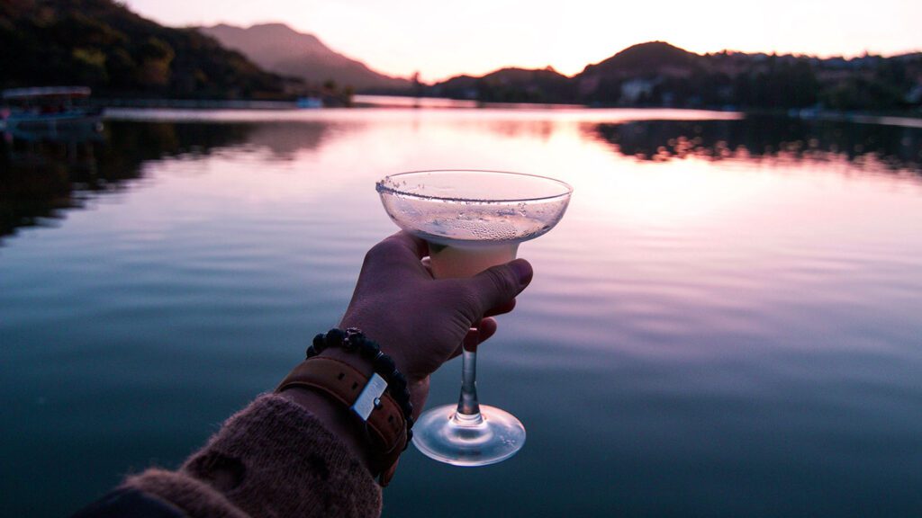 Cheers over a lake at sunset