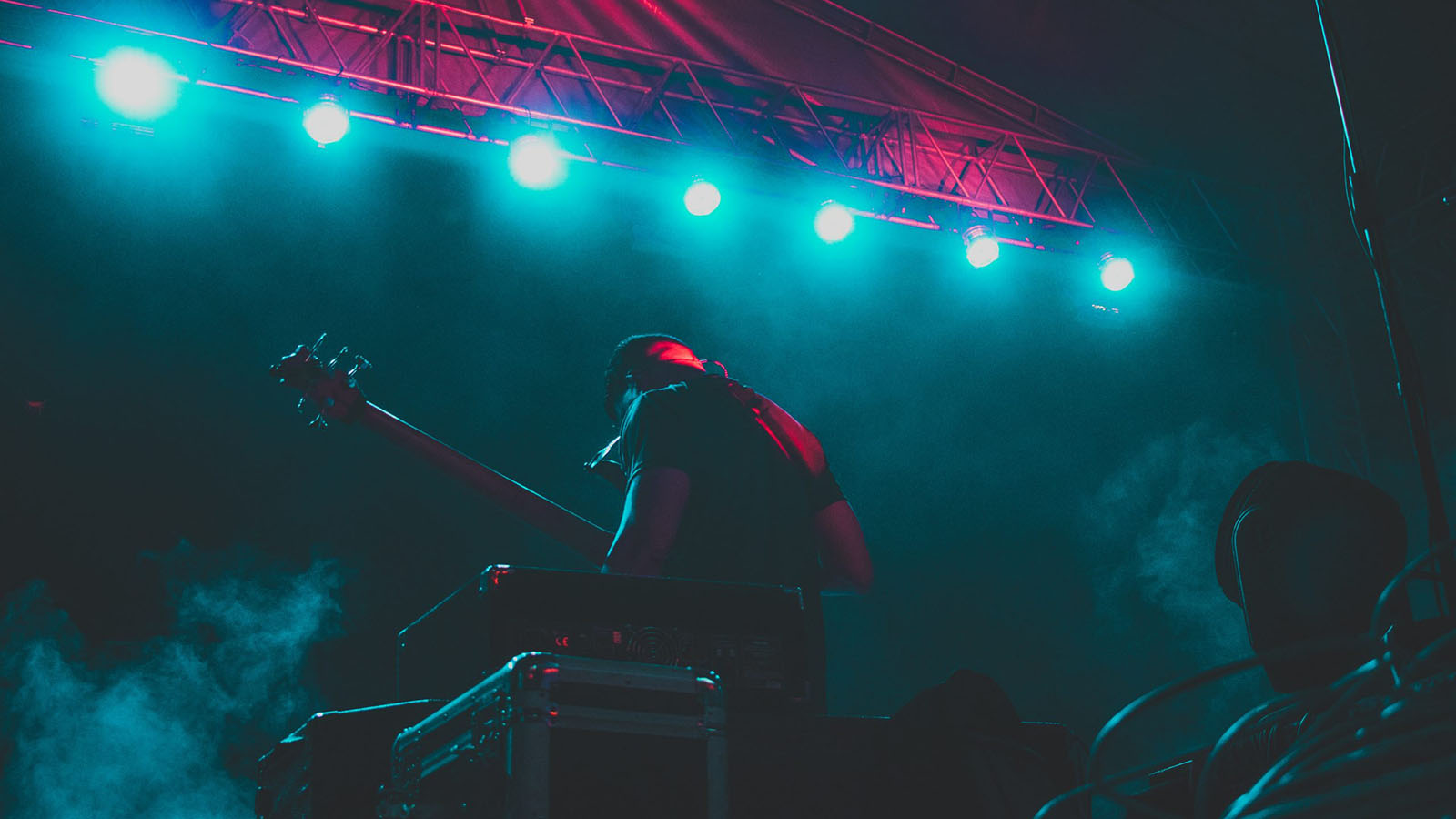 Guitar player on stage with blue lights