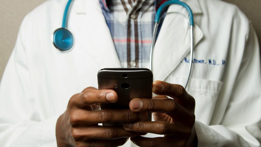 Doctor holding a smartphone.