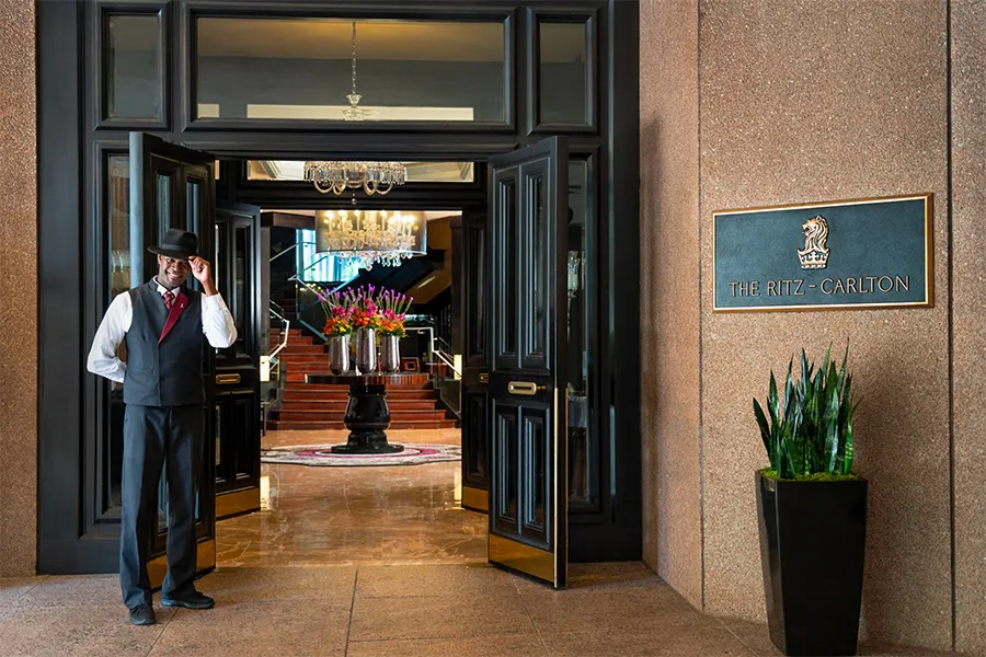 A conceptual architectural infographic detailing the Ritz-Carlton Gold Standards, illustrating how internal employee training, global daily rituals, and customer experience align under a single strategic narrative.